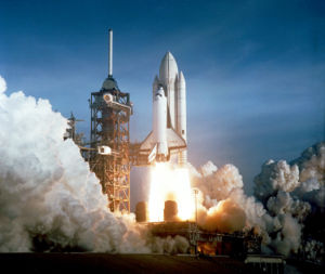 The Space Shuttle Columbia seconds after the launch of its maiden flight, on April 12, 1981 (NASA).  This was one of only two missions that had a painted external tank (tallest vehicle component that's shown in white).