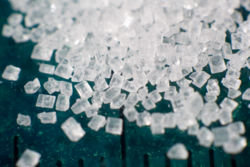 Magnification of typical sugar showing monoclinic hemihedral crystal stucture.