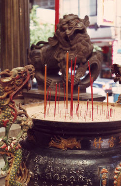 A Taoist Temple in Taiwan. The religious practice of incense burning as well as images of the Fu Dog and Dragon guardian spirits can be seen.