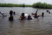 Children swimming near Lamin Lodge.