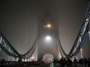 Evening fog obscures London's Tower Bridge from passers by.