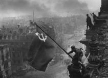 In this Soviet photograph from May 2, 1945, Red Army soldiers are raising the Soviet flag on the roof of the Reichstag.