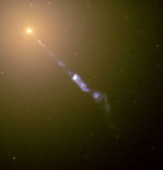 The jet emitted by the galaxy M87 in this image is thought to be caused by a supermassive black hole at the galaxy's centre