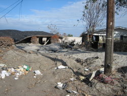 Severely damaged homes in piles of silt near the upper London Avenue Canal breach.