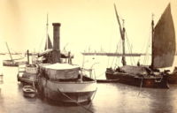 A steamer, Bombay docks, 1870s, with bigger ships farther out in the sea. Oriental and India Office Collection. British Library.