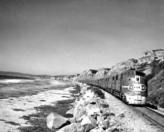 The San Diegan, led by a pair of EMD E1 locomotives, rolls south along the Pacific Coast through San Clemente.