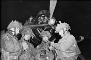 British Pathfinders synchronizing their watches in front of an Armstrong Whitworth Albemarle.