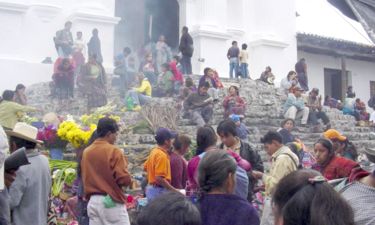 Buyers bargain for good prices while sellers put forth their best front in Chichicastenango Market, Guatemala.