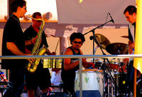 A modern salsa band lineup including less traditional salsa instruments such as a saxophone and a full drumset.