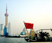 PRC flag before a rapidly modernizing Shanghai.