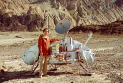 Carl Sagan with a model of the Viking Mars Lander at Death Valley, California.