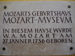 Plaque on wall outside Mozart's birthplace at Getreidegasse 9, Salzburg, Austria.