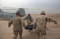 US Army (USA) Soldiers assigned to 2-7 Cavalry, 2nd Brigade Combat Team (BCT), 1st Cavalry Division, rush a wounded Soldier from Apache Troop to a waiting U.S. Marine Corps (USMC) CH-46E Sea Knight helicopter during operation in Fallujah, Iraq. Date Shot: 12 Nov 2004.