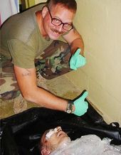 Spc. Charles Graner poses over Manadel al-Jamadi's corpse.