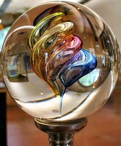 Glass can be made transparent and flat, or into other shapes and colors as shown in this sphere from the Verrerie of Brehat in Brittany.