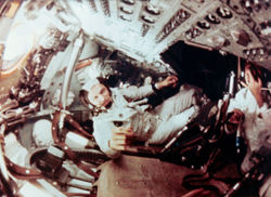 In-flight footage of the crew taken while they were in orbit around the Moon; Frank Borman is in the center.