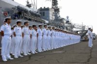 Sailors aboard the JMSDF training vessel JDS Kashima stand in ranks.