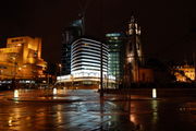 The Parish Church of St. Nicholas and the Atlantic Tower hotel near Pier Head. The Atlantic Tower was designed to resemble the prow of a ship to reflect Liverpool's maritime history.